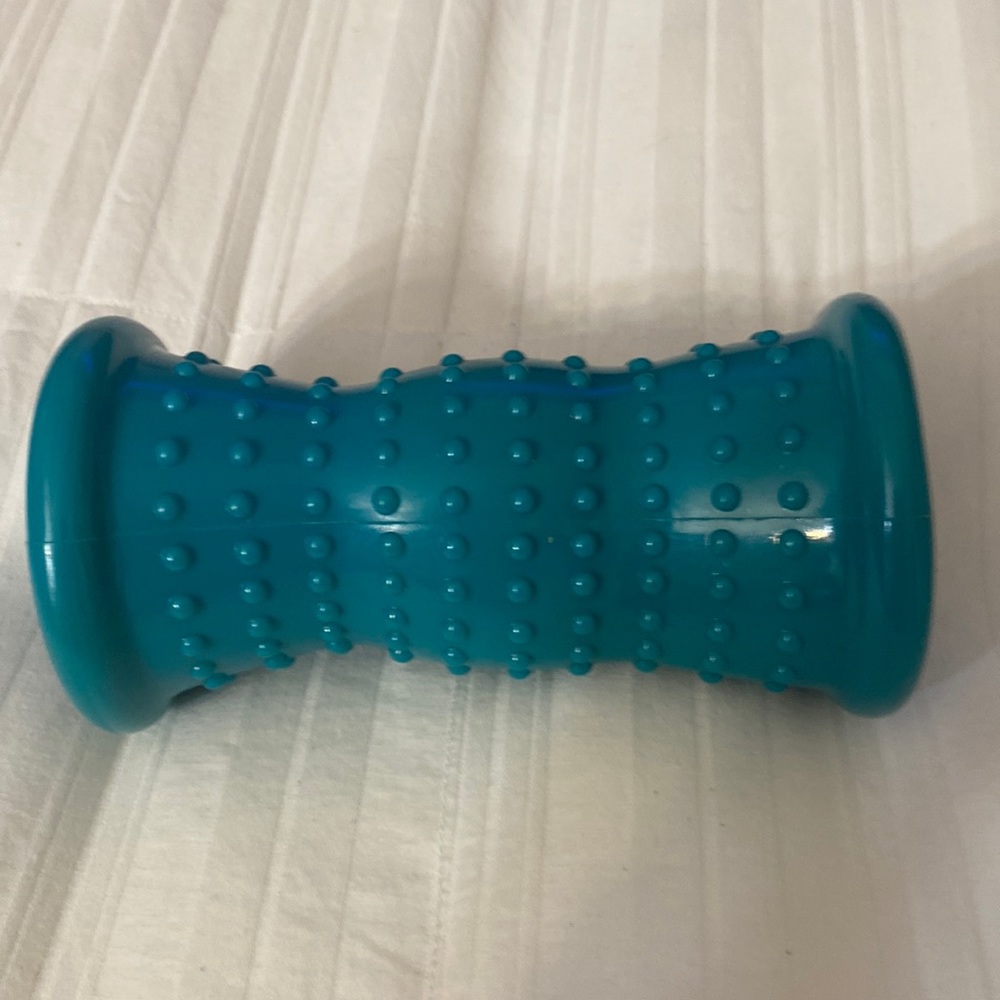 SOLD!!!!!!!!!!!!!!!!!!!!!!!!!!!!!!!!!A teal, hard, plastic foot rolling massager